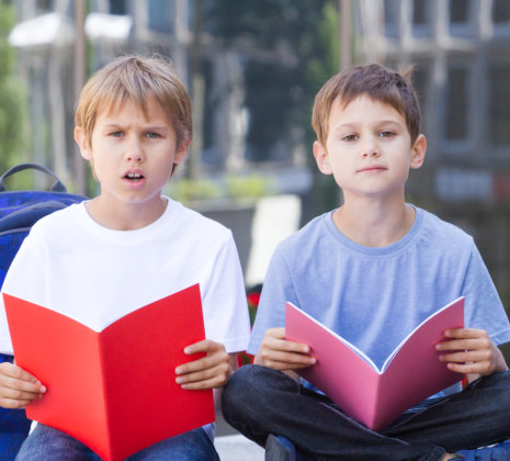 two kids holding their books
